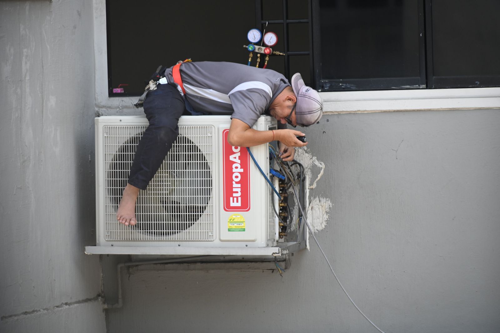 An outdoor heat pump unit installed beside a home